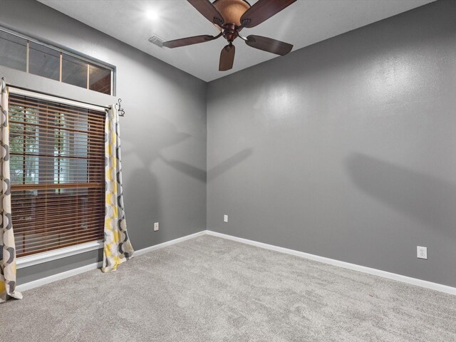 carpeted empty room with ceiling fan