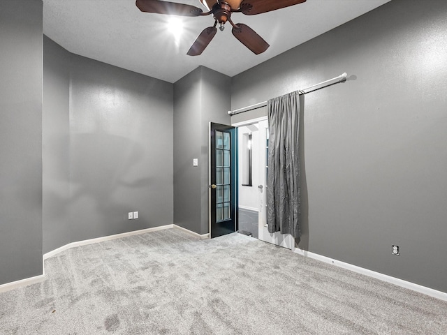 spare room with ceiling fan and carpet flooring