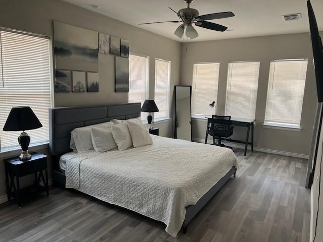 bedroom featuring dark wood-type flooring and ceiling fan