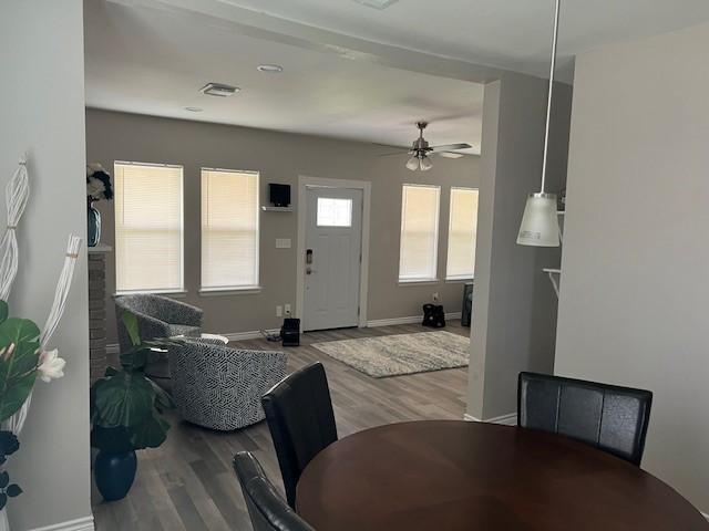 dining room with hardwood / wood-style flooring and ceiling fan