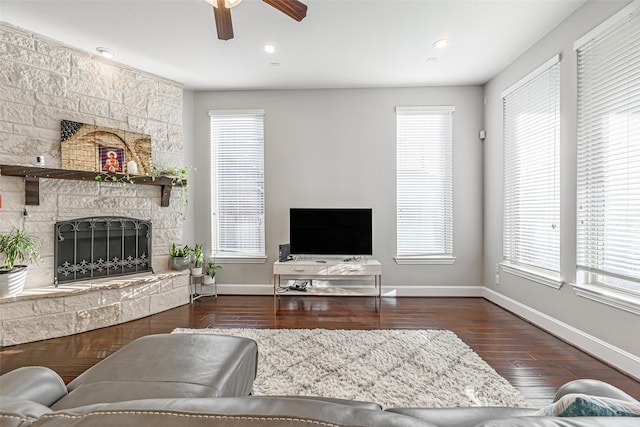 living room with ceiling fan, recessed lighting, a fireplace, wood finished floors, and baseboards