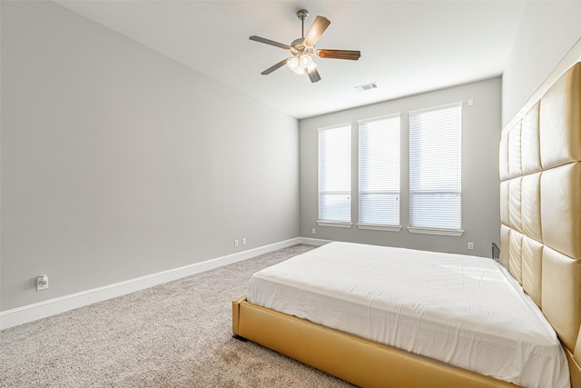 bedroom with carpet, visible vents, ceiling fan, and baseboards