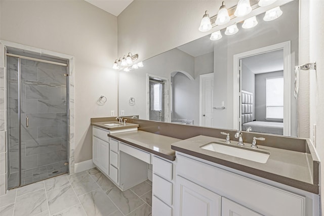 full bathroom with marble finish floor, a sink, a shower stall, and double vanity