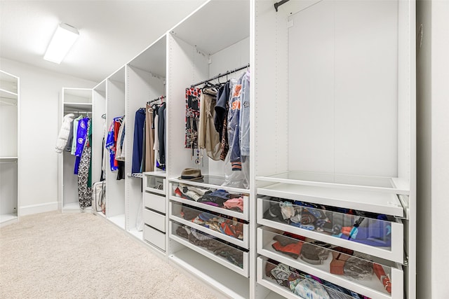 walk in closet with carpet