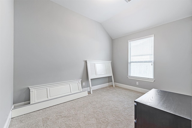 unfurnished bedroom with vaulted ceiling, carpet, and baseboards