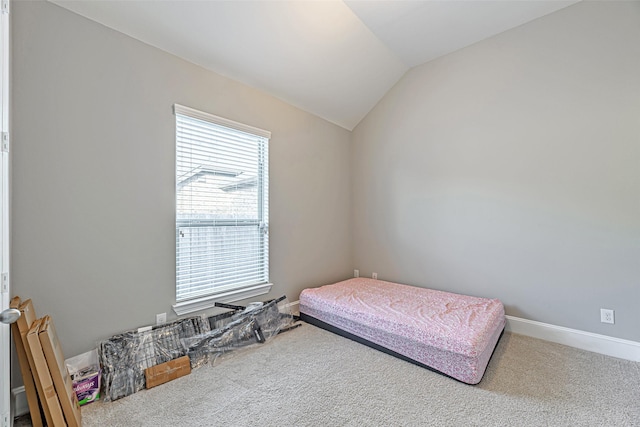 bedroom featuring vaulted ceiling, carpet, and baseboards