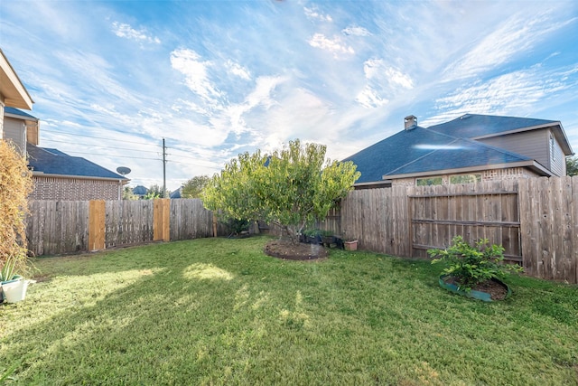 view of yard with a fenced backyard