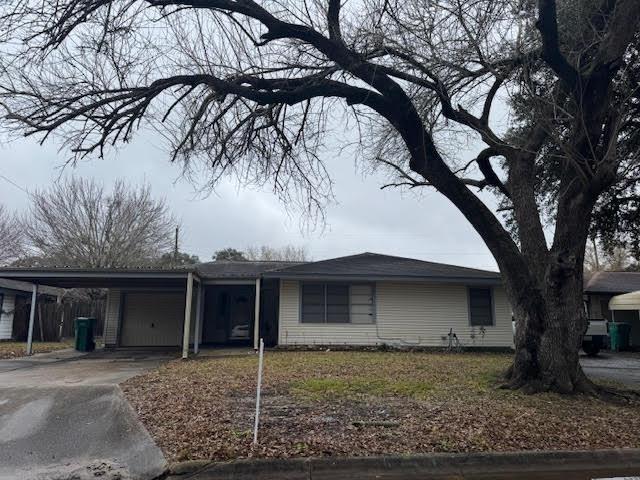 ranch-style house featuring a carport