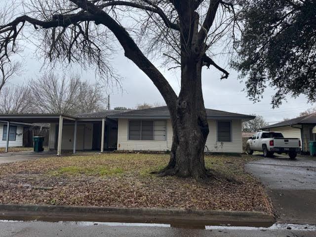 ranch-style home featuring a carport