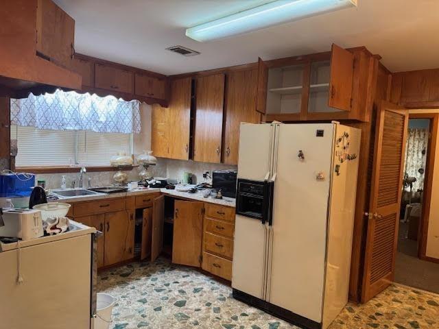 kitchen with sink and white fridge with ice dispenser