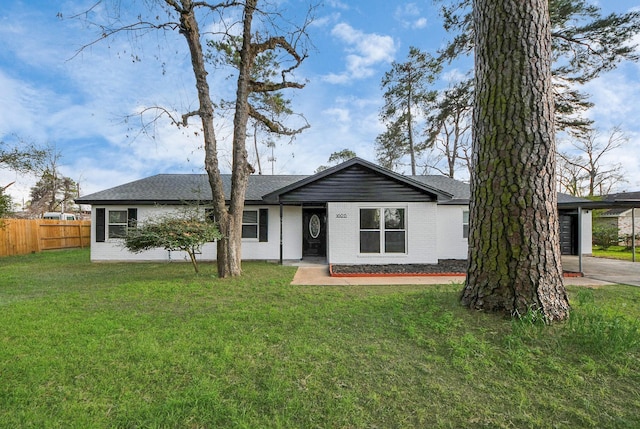 single story home featuring a front lawn and a carport