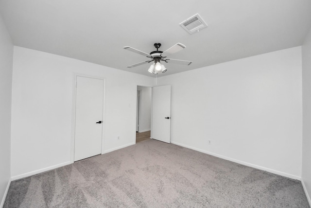 unfurnished bedroom with ceiling fan and light colored carpet