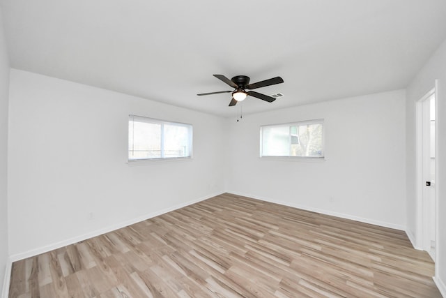 unfurnished room featuring light wood-type flooring, ceiling fan, and a healthy amount of sunlight