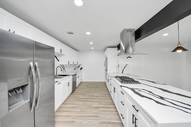 kitchen featuring exhaust hood, light stone countertops, white cabinetry, and stainless steel appliances