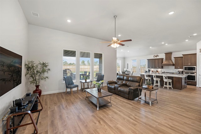 living area featuring recessed lighting, baseboards, light wood-style floors, and ceiling fan