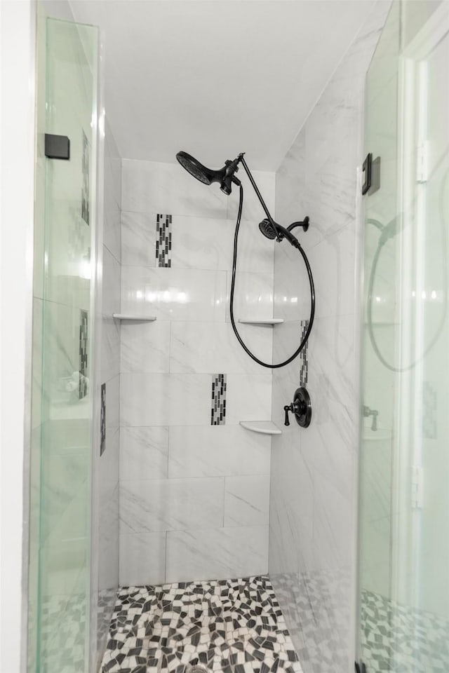 bathroom with a shower with door