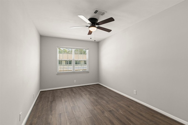 spare room with ceiling fan and dark wood-type flooring