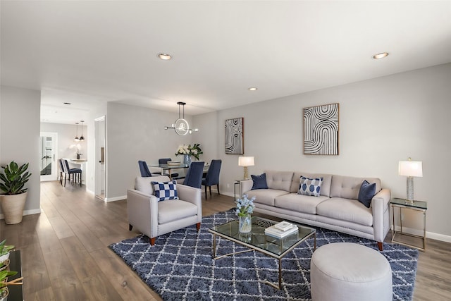 living room featuring hardwood / wood-style flooring and a chandelier