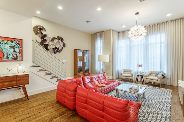 living room with a notable chandelier and wood-type flooring