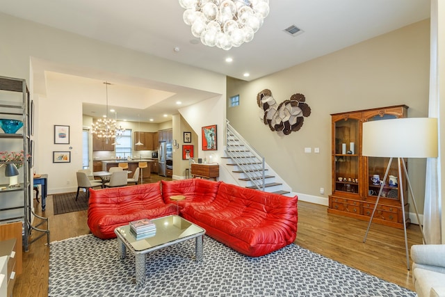 living room with a chandelier and dark hardwood / wood-style flooring