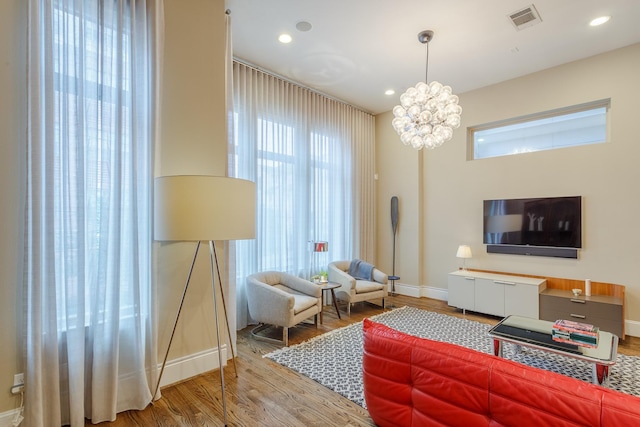 living room featuring hardwood / wood-style flooring and a chandelier