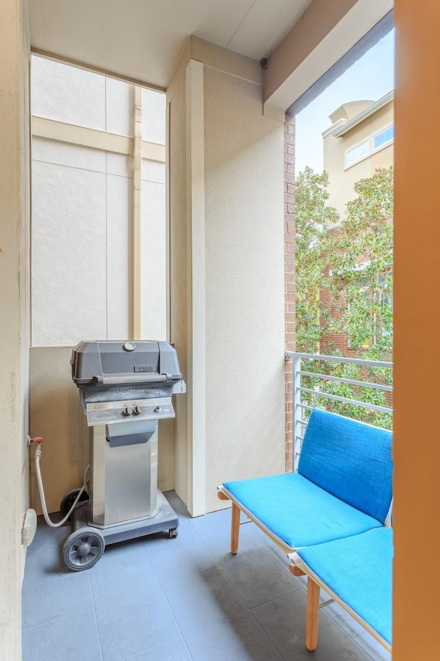 view of patio with area for grilling and a balcony