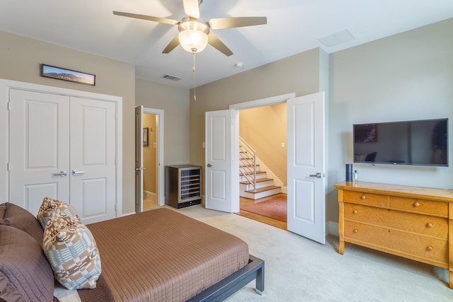 carpeted bedroom with a closet and ceiling fan