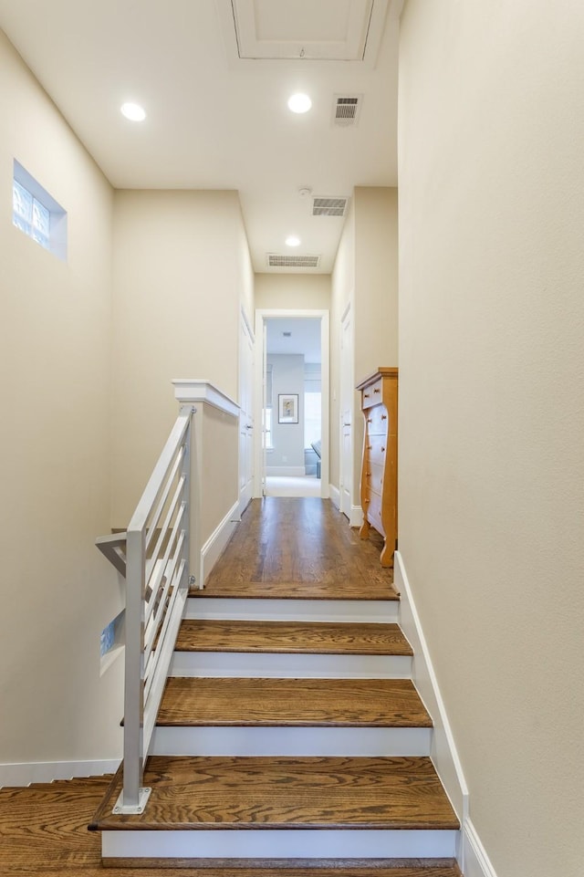 stairs featuring hardwood / wood-style flooring