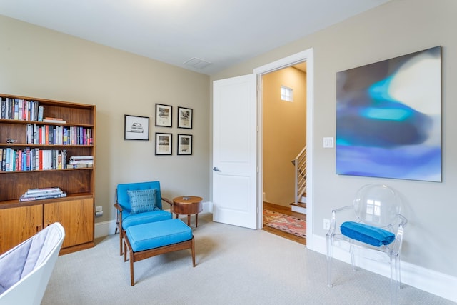 sitting room featuring light carpet