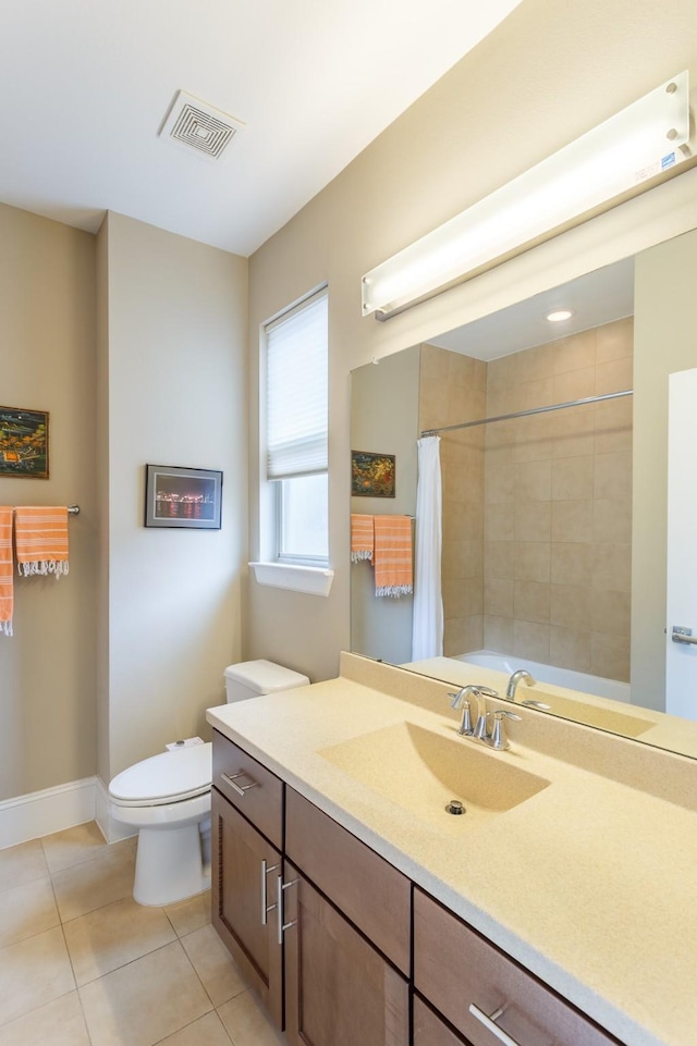 bathroom with tile patterned floors, toilet, vanity, and walk in shower