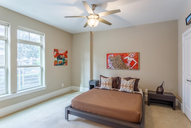 bedroom with ceiling fan and light colored carpet