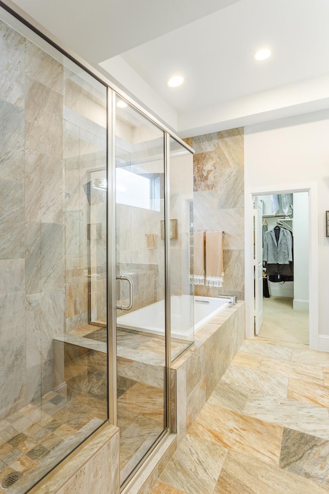 bathroom featuring shower with separate bathtub