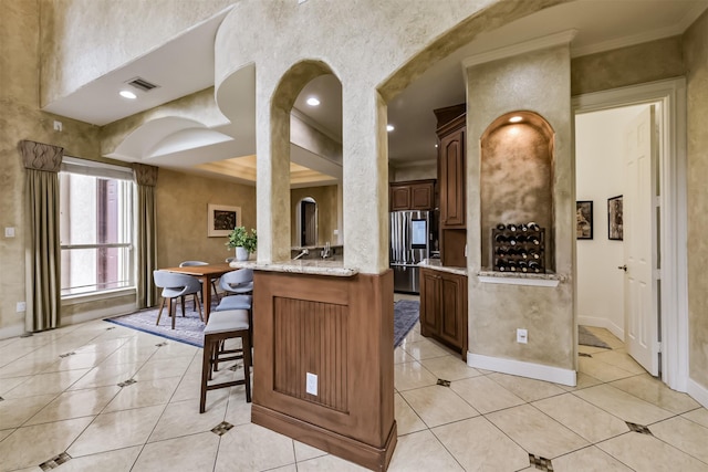 kitchen featuring light tile patterned floors, visible vents, baseboards, a peninsula, and smart refrigerator