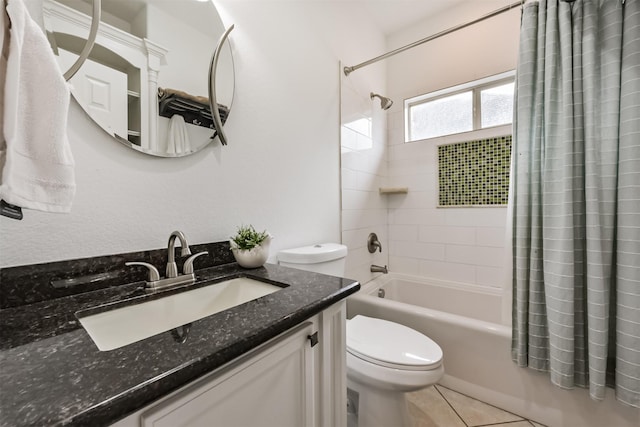 bathroom featuring toilet, vanity, shower / bath combo with shower curtain, and tile patterned floors