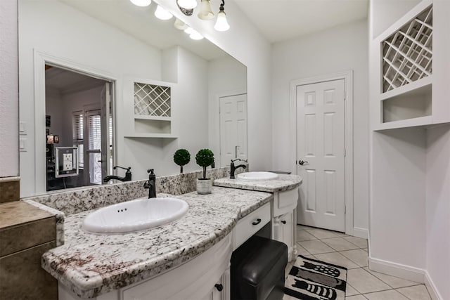 bathroom with tile patterned flooring, vanity, and baseboards