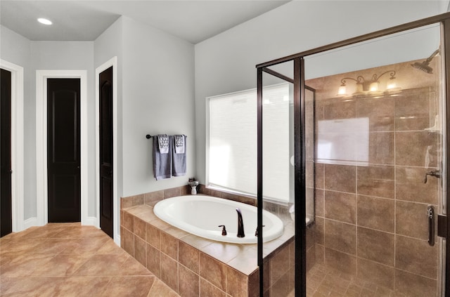 bathroom featuring separate shower and tub and tile patterned flooring