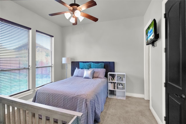 bedroom with ceiling fan and light carpet