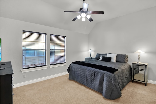 bedroom with lofted ceiling, light colored carpet, and ceiling fan