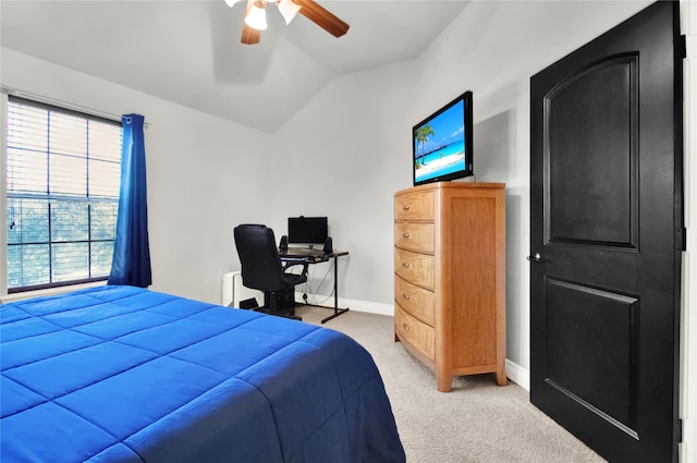 bedroom with vaulted ceiling, ceiling fan, and carpet flooring