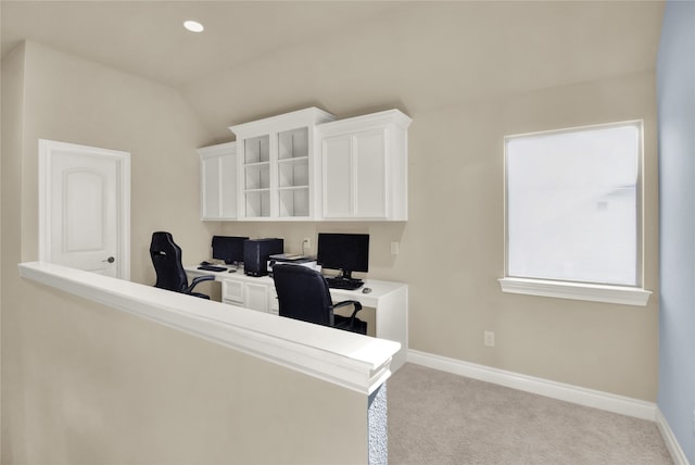 office area featuring vaulted ceiling and light carpet