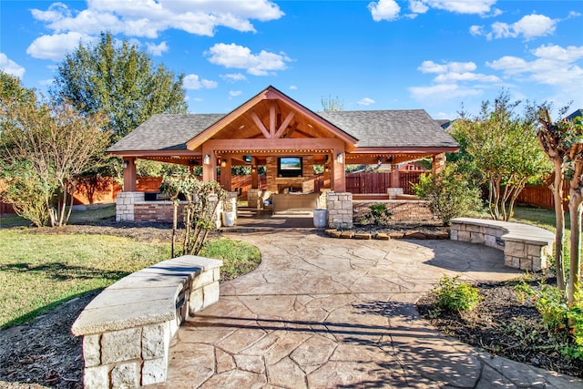 view of front of home with a patio area, a front yard, and a gazebo