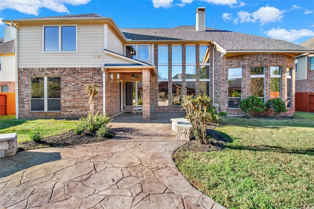 view of front of house with a patio and a front yard