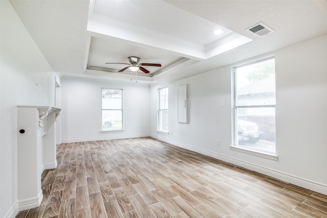 unfurnished living room featuring ceiling fan, light hardwood / wood-style flooring, crown molding, and a raised ceiling