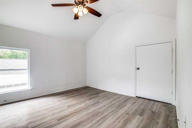 additional living space with light hardwood / wood-style floors, vaulted ceiling, and ceiling fan
