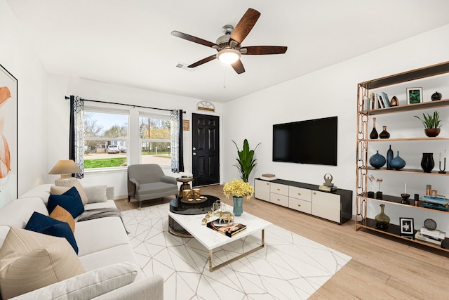 living room with ceiling fan and light wood-type flooring