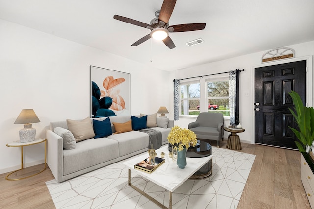 living room with ceiling fan and light hardwood / wood-style floors