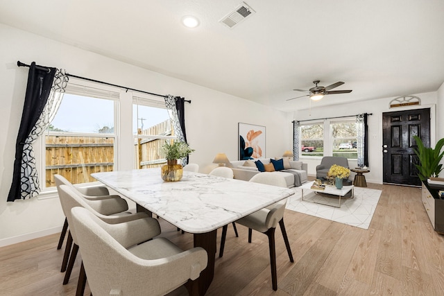 dining space featuring light wood-type flooring and ceiling fan