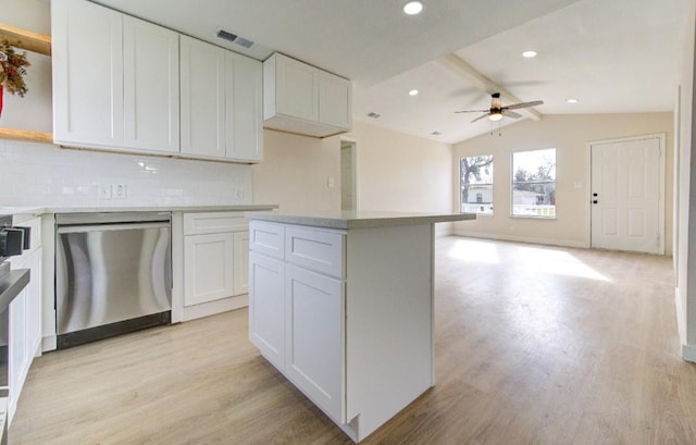 kitchen with stainless steel dishwasher, light wood-type flooring, and white cabinetry