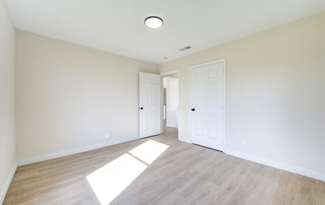 unfurnished bedroom with a closet and light hardwood / wood-style flooring