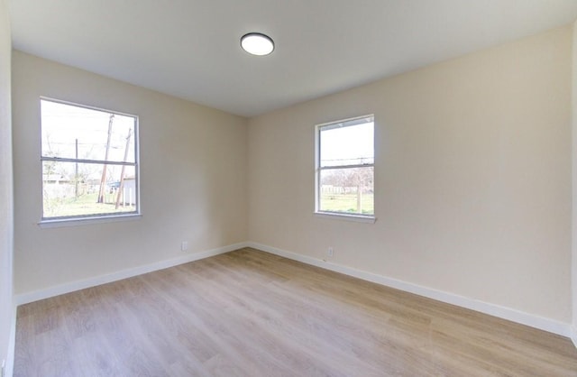 empty room featuring light wood-type flooring and plenty of natural light